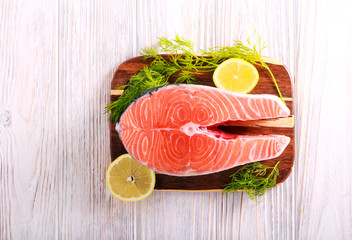 Raw salmon fish steaks on cutting board