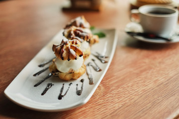 Choux cream on a narrow white plate