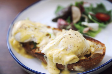 Egg benedict , poached eggs with toast on wood background , English Breakfast