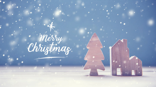 Merry Christmas With Christmas Tree And Home On Wood Background.