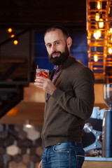 businessman male brunette beard glass hold cafe office house loft brave bearded hipster mulled wine