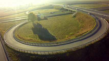 Aerial Top View of highway intersection junction summer morning with car