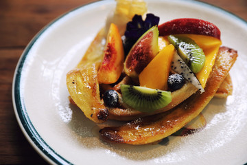 Dessert baked Waffle with fruits kiwo grape berry and vanilla ice cream vintage style