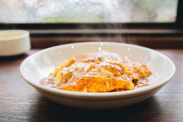 Curry rice with omelet Japanese style on wood background film vintage style