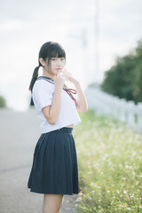 Portrait of asian japanese school girl costume looking at park outdoor film vintage style