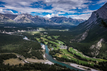 Lovely view from Tunnel Mountain summit in Banff National Park in Alberta Canada shows the Bow Valley below with its lush trees and a winding Bow River