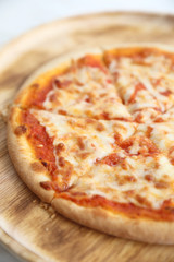 pizza margarita on wood dish in coffee shop background