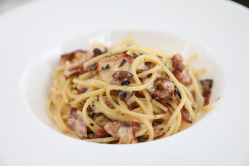 Spaghetti carbonara , Spaghetti white sauce with cheese bacon in outdoor restaurant italian food