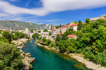 Fototapeta na wymiar Sightseeing in Bosnia and Herzegovina. The Old Bridge, Stari Most, with emerald river Neretva in Mostar old town.