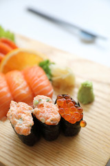 Salmon sushi and sashimi on wood plate Japanese food
