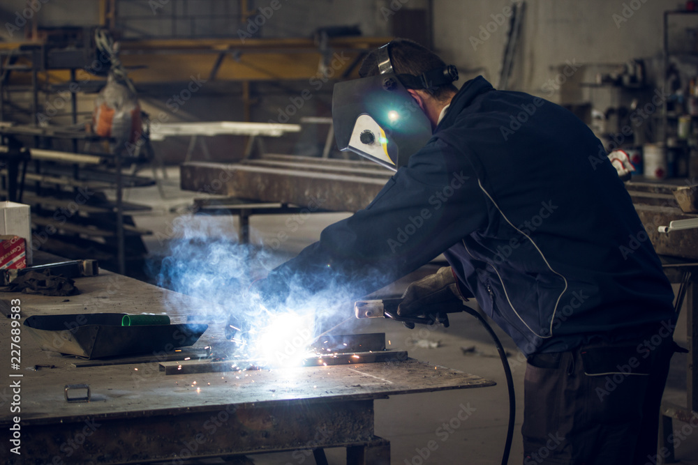 Wall mural welder working man