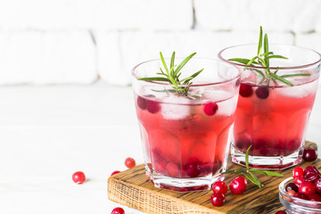 Cocktail with cranberry, vodka, rosemary and ice.