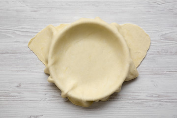 Raw dough for preparation apple pie, top view. Close-up.