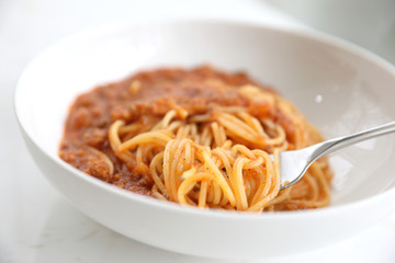 spaghetti Bolognese with minced beef and tomato sauce garnished with parmesan cheese and basil , Italian food