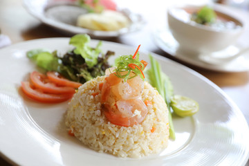 Fried rice with shrimp on wooden table