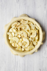 Preparation of apple pie on a white wooden table, top view. Closeup.