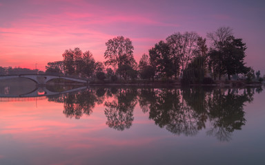 Sunset view from the lake on the small island with bridge in Ivano-Frankivsk city