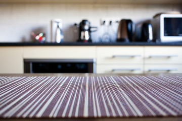 blurred  kitchen interior - focus on napkin and desk space