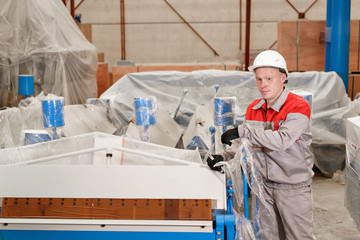 manufacture workshop. Worker unpacks the machine in the warehouse. the production of ventilation and gutters. Tool and bending equipment for sheet metal.