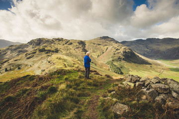 Fototapeta premium Old man looking at a mountain view