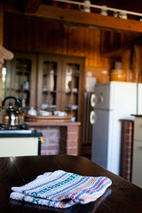 blurred rustic kitchen interior - focus on napkin and desk space