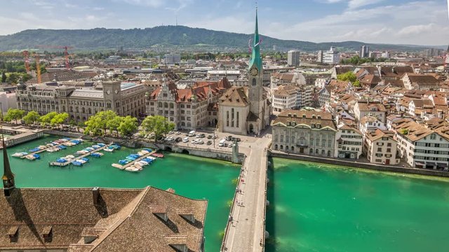 Aerial time lapse video of the Munsterbrucke stone bridge over the Limmat river and Fraumunster Church in Zurich, Switzerland