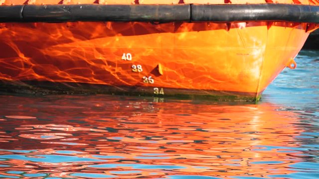 Waterline numbers on bow and stern of a vessel in port. Ships draught markings and water line in slow motion.