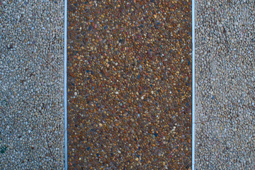Texture of gravel's sidewalk or wall wich metal strips