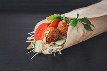Shawarma sandwich - fresh roll of thin lavash (pita bread) filled with grilled meat, mushrooms,...