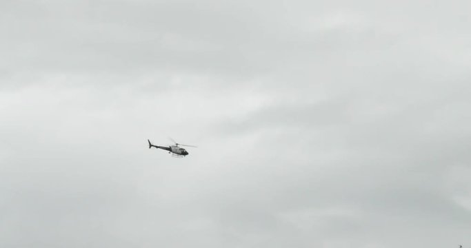 Helicopter flying low through the city. Police searching for a suspect. Shot in 4k slow motion