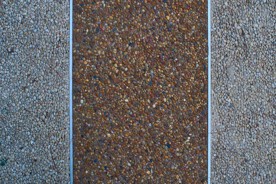 Texture of gravel's sidewalk or wall wich metal strips - Powered by Adobe