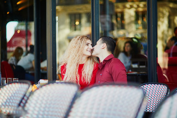 Beautiful romantic couple in Parisian outdoor cafe