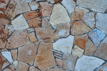 Texture of stone masonry, orange, yellow and white stones