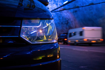 Detail of a headlamp of a modern van at the night