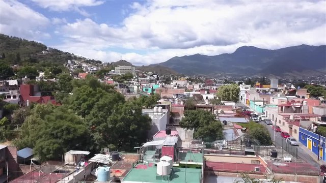 Descending aerial shot over Oaxaca City in Oaxaca, Mexico on a sunny day.