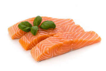 Fresh salmon fillet with basil on the white background.