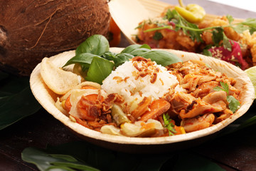 various street food with chicken wings on rustic background. balinese nasi campur and indian and brasilian street food. © beats_