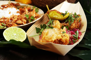 various street food with chicken wings on rustic background. balinese nasi campur and indian and...