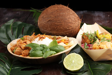 various street food with chicken wings on rustic background. balinese nasi campur and indian and brasilian street food. © beats_