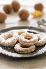 Sand dough biscuits, coffee and walnuts on a linen tablecloth. Rustic style.