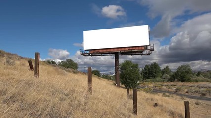 Time lapse billboard ready for your information with rolling clouds behind it