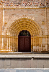 Ancient ornate wooden door of a church in Ciudad Real, Spain.