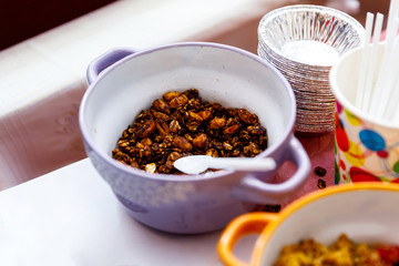 Homemade granola with nuts and seeds in thaplate for healthy breakfast