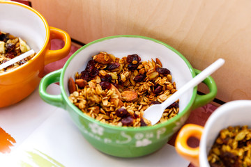 Homemade granola with nuts and seeds in thaplate for healthy breakfast