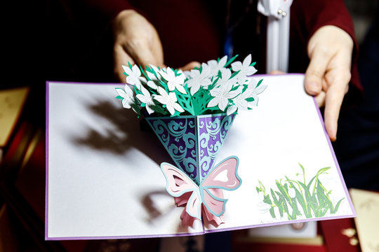 Kirigami greeting postcard for holiday, with 3D paper figure inside