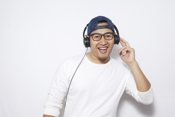 Happy Young Man Dancing while Listening Music