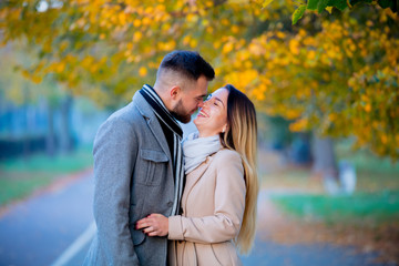 young couple in autumn season alley. Fall season