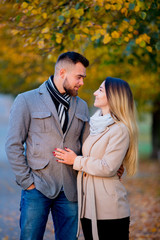 Fototapeta premium young couple in autumn season alley. Fall season