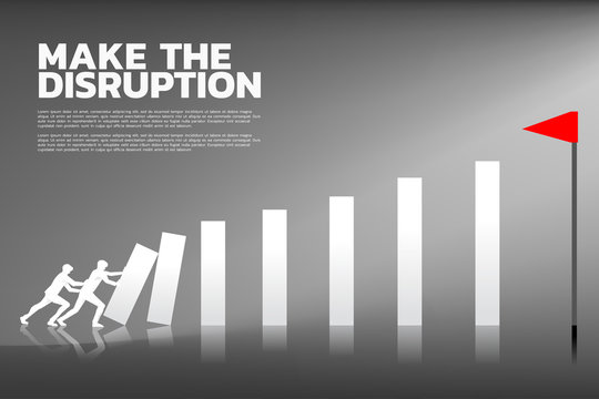 Silhouette of two businessman pushing the block to create domino effect to hit the flag. business concept of teamwork. start up team try to make the domino effect to disrupt industry
