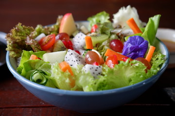 fruit salad and vegetable salad on wood table